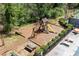 Aerial view of a community playground with swings, slide, picnic table, and lounge chairs at 1755 Pinetree Pass Sw Ln, Lilburn, GA 30047