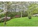 Expansive backyard with landscaped garden and trees, creates a serene backdrop at 4086 Norton Se Pl, Smyrna, GA 30082