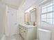 Bright bathroom featuring double sinks, modern fixtures, decorative mirrors and classic black and white tile flooring at 4086 Norton Se Pl, Smyrna, GA 30082