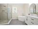 Modern bathroom featuring a glass shower, soaking tub, and vanity with elegant countertops and fixtures at 4086 Norton Se Pl, Smyrna, GA 30082