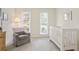 Cozy Bedroom with a white crib, comfortable glider, and neutral decor at 4086 Norton Se Pl, Smyrna, GA 30082