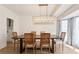 Elegant dining room featuring a long wooden table with seating for six and a modern chandelier at 4086 Norton Se Pl, Smyrna, GA 30082