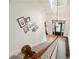Bright foyer from stairway showing the front door, chandelier, hardwood floors, and decorative wall art at 4086 Norton Se Pl, Smyrna, GA 30082