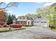 Charming home showcasing a well-manicured lawn, mature landscaping, a brick facade, and a convenient two-car garage at 4086 Norton Se Pl, Smyrna, GA 30082