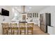 Bright, open kitchen featuring stainless steel appliances, an island with bar seating, and a separate workstation at 4086 Norton Se Pl, Smyrna, GA 30082