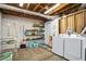 Functional laundry room with shelving, storage, utility sink, and modern washer and dryer units at 4086 Norton Se Pl, Smyrna, GA 30082