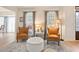 Comfortable living room featuring stylish chairs, an ottoman, a decorative rug, and soft, natural light at 4086 Norton Se Pl, Smyrna, GA 30082