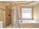Bathroom featuring tile shower, garden tub, and a window at 4095 Boles Creek Dr, Duluth, GA 30096