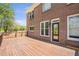 Exterior view of the wooden deck with a brick house and black door nearby at 4095 Boles Creek Dr, Duluth, GA 30096