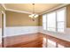 Dining room with natural light, hardwood floors, and wainscoting detail on the walls at 4095 Boles Creek Dr, Duluth, GA 30096