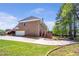 A side view of the brick home, showcasing the back patio and driveway at 4095 Boles Creek Dr, Duluth, GA 30096