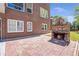 Backyard fireplace on a brick patio, with the brick exterior of the home in the background at 4095 Boles Creek Dr, Duluth, GA 30096