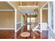 Inviting foyer with hardwood floors, staircase, and entry to other rooms of the home at 4095 Boles Creek Dr, Duluth, GA 30096