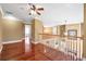 Open hallway with wood floors and railing providing sight line to the floor below at 4095 Boles Creek Dr, Duluth, GA 30096