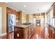 View of the kitchen island flowing into the living room which features a fireplace at 4095 Boles Creek Dr, Duluth, GA 30096