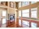 Living room with hardwood floors, a fireplace, large windows, and access to other rooms at 4095 Boles Creek Dr, Duluth, GA 30096