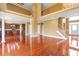 Open-concept living room featuring a second story balcony overlooking hardwood floors and a glimpse into the kitchen at 4095 Boles Creek Dr, Duluth, GA 30096