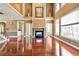 Spacious living room featuring hardwood floors, fireplace, and large windows allowing for lots of natural light at 4095 Boles Creek Dr, Duluth, GA 30096