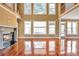 Bright living room featuring hardwood floors, a fireplace, large windows, and natural light at 4095 Boles Creek Dr, Duluth, GA 30096
