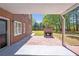 View of the patio with a stone fireplace and brick pavers in the backyard at 4095 Boles Creek Dr, Duluth, GA 30096