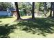 Spacious backyard with lush grass, outbuildings, and trees providing shade at 5048 Westbrook Rd, Union City, GA 30291