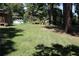 Expansive backyard featuring lush grass, mature trees, and outbuildings at 5048 Westbrook Rd, Union City, GA 30291