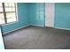 Carpeted bedroom featuring neutral trim and turquoise walls, providing a calming atmosphere at 5048 Westbrook Rd, Union City, GA 30291