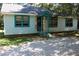 Close-up of the front of a light blue home with bars on the windows at 5048 Westbrook Rd, Union City, GA 30291