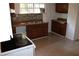 Functional kitchen featuring wood cabinets, laminate counters, tile floors and stone-look backsplash at 5048 Westbrook Rd, Union City, GA 30291
