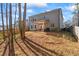 Large backyard with a covered patio, offering serene outdoor living space with mature trees at 75 Glen Abbey Cir, Fairburn, GA 30213