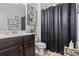 Bathroom featuring a dark vanity and patterned curtain at 75 Glen Abbey Cir, Fairburn, GA 30213