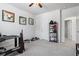 Neutral bedroom featuring carpet, ceiling fan, and adjacent room at 75 Glen Abbey Cir, Fairburn, GA 30213