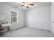 Bright, empty bedroom with ceiling fan and large window at 75 Glen Abbey Cir, Fairburn, GA 30213
