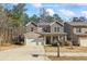 Charming two-story home featuring a brick and stone facade, attached two-car garage, and inviting front porch at 75 Glen Abbey Cir, Fairburn, GA 30213