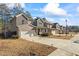 View of new two-story homes in a suburban neighborhood, showcasing front lawns and attached garages at 75 Glen Abbey Cir, Fairburn, GA 30213