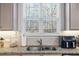 Close up of the kitchen sink and window overlooking natural scenery at 75 Glen Abbey Cir, Fairburn, GA 30213