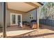 Inviting covered patio, perfect for outdoor dining and relaxation, with views of the natural landscape at 75 Glen Abbey Cir, Fairburn, GA 30213