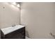 Powder room with dark wood vanity, white sink, and modern fixtures at 774 Mary Ann Ne Dr, Marietta, GA 30068