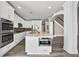 Modern kitchen features stainless appliances, white cabinets, and a center island with bar seating at 774 Mary Ann Ne Dr, Marietta, GA 30068