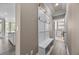Inviting mudroom features built-in bench with hooks, tile floor and natural light at 774 Mary Ann Ne Dr, Marietta, GA 30068