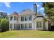 Gorgeous rear exterior featuring numerous windows for abundant natural light and a tall chimney at 774 Mary Ann Ne Dr, Marietta, GA 30068