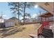 Spacious backyard features a shed, mature trees, and a covered porch, ideal for relaxation at 8554 Taylor Rd, Riverdale, GA 30274