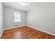 Bedroom with hardwood floors, one window, and neutral wall paint at 8554 Taylor Rd, Riverdale, GA 30274