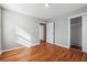 Bright bedroom offers hardwood floors, closet, and neutral walls for a calm and inviting space at 8554 Taylor Rd, Riverdale, GA 30274