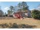 Brick home with a red porch and steps, set in a spacious, tree-filled yard at 8554 Taylor Rd, Riverdale, GA 30274