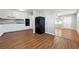 Bright kitchen area with white cabinets, black appliances, and hardwood-style floors at 8554 Taylor Rd, Riverdale, GA 30274