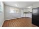 Open kitchen and dining area with white cabinets, and modern black refrigerator at 8554 Taylor Rd, Riverdale, GA 30274