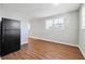 Clean kitchen with white cabinets, a black fridge, and light hardwood-style flooring at 8554 Taylor Rd, Riverdale, GA 30274