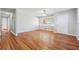 Spacious living room featuring hardwood floors, a ceiling fan, and a bright window at 8554 Taylor Rd, Riverdale, GA 30274