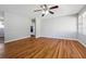Bright living room with hardwood floors, ceiling fan, and fresh neutral paint at 8554 Taylor Rd, Riverdale, GA 30274